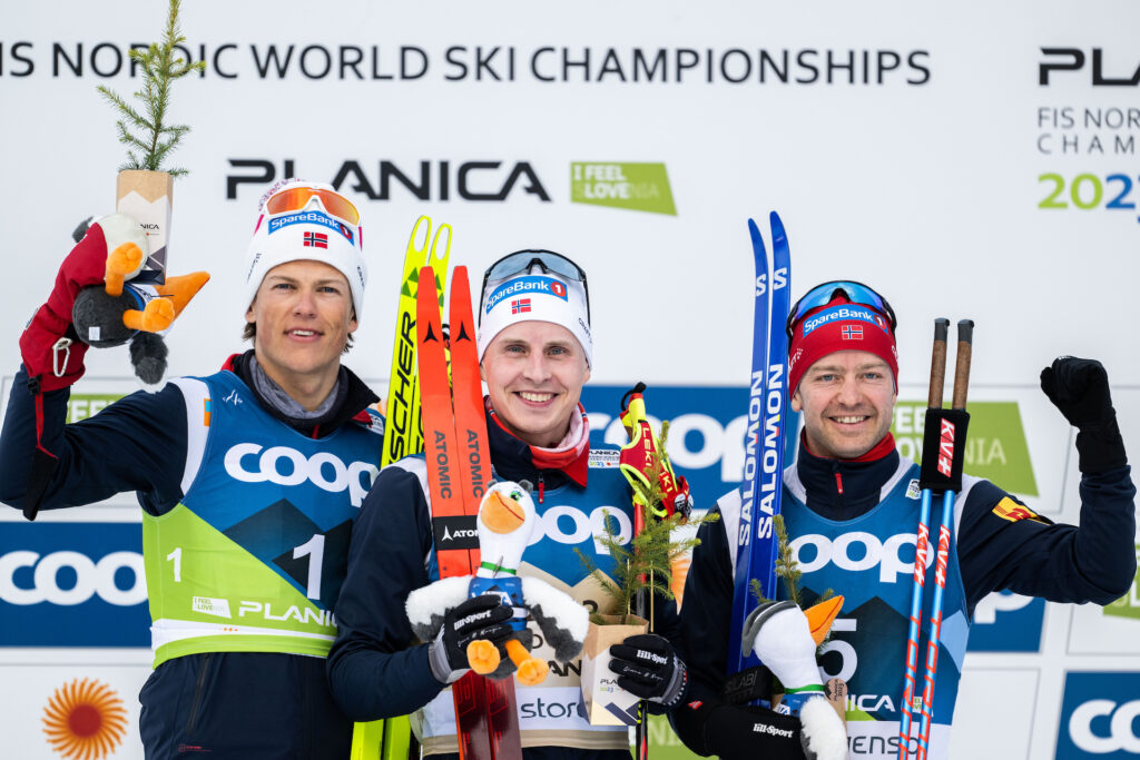 Johannes Høsflot Klæbo of Norway, Simen Hegstad Krüger of Norway and Sjur Røthe of Norway during the flower ceremony after competing in the Men's Cross Country Skiing Skiathlon during the FIS Nordic Ski World Championships on February 24, 2023 in Planica.