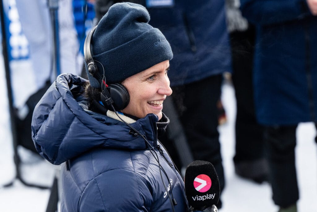 Marit Bjørgen of Norwegian broadcaster Viaplay in the mixed zone after men's 10 km free technique mass start during Tour de Ski on January 7, 2024 in Val di Fiemme.