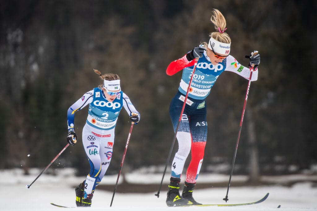 Ebba Andersson of Sweden and Therese Johaug of Norway competes in the Women's Cross Country Skiing Skiathlon during the FIS Nordic Ski World Championships on February 27, 2021 in Oberstdorf.