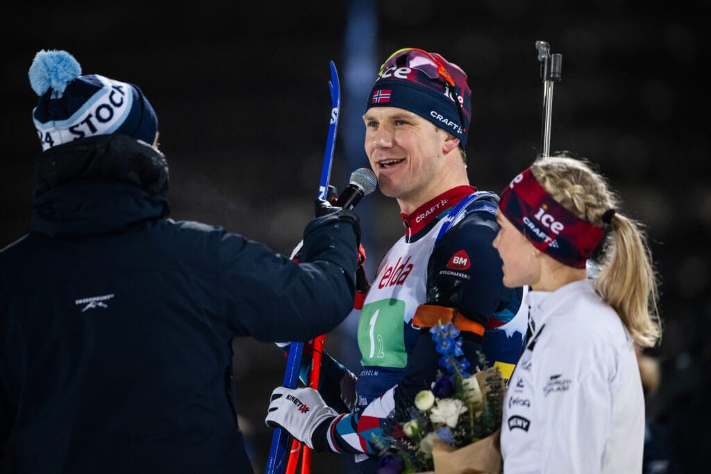 240226 Vetle Sjåstad Christiansen and Juni Arnekleiv of Norway is interviewed after winning single mixed relay during Skidskyttekampen on February 26, 2024 in Stockholm.