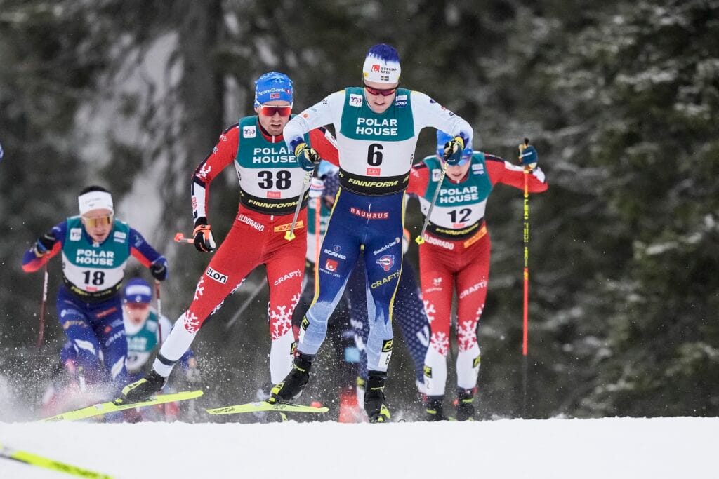 Emil Iversen of Norway, Jens Burman of Sweden and Andreas Fjorden Ree of Norway compete in men's 20 km mass start during the FIS Cross-Country World Cup on December 1, 2024 in Ruka.