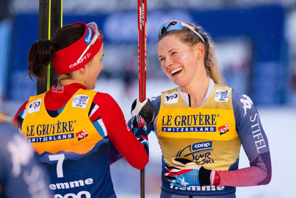 Heidi Weng of Norway and Jessie Diggins of United States celebrate after competing in women's 10 km free technique mass start during Tour de Ski on January 7, 2024 in Val di Fiemme. 