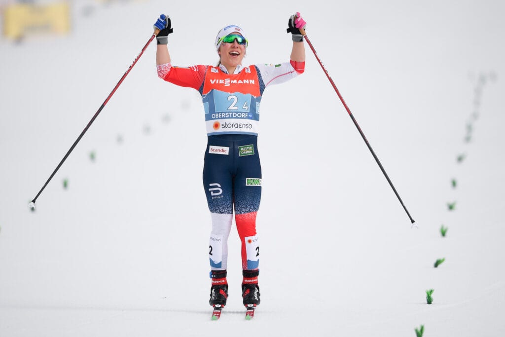 Helene Marie Fossesholm of Norway celebrates as she crosses the finishline in the Women's Cross Country Skiing 4 x 5km Relay during the FIS Nordic Ski World Championships on March 4, 2021 in Oberstdorf. 