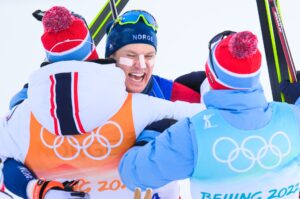 Vetle Sjåstad Christiansen of Norway celebrates with team mates after winning men's biathlon 4 x 7,5 km relay during day 11 of the 2022 Winter Olympics on February 15, 2022 in Zhangjiakou.