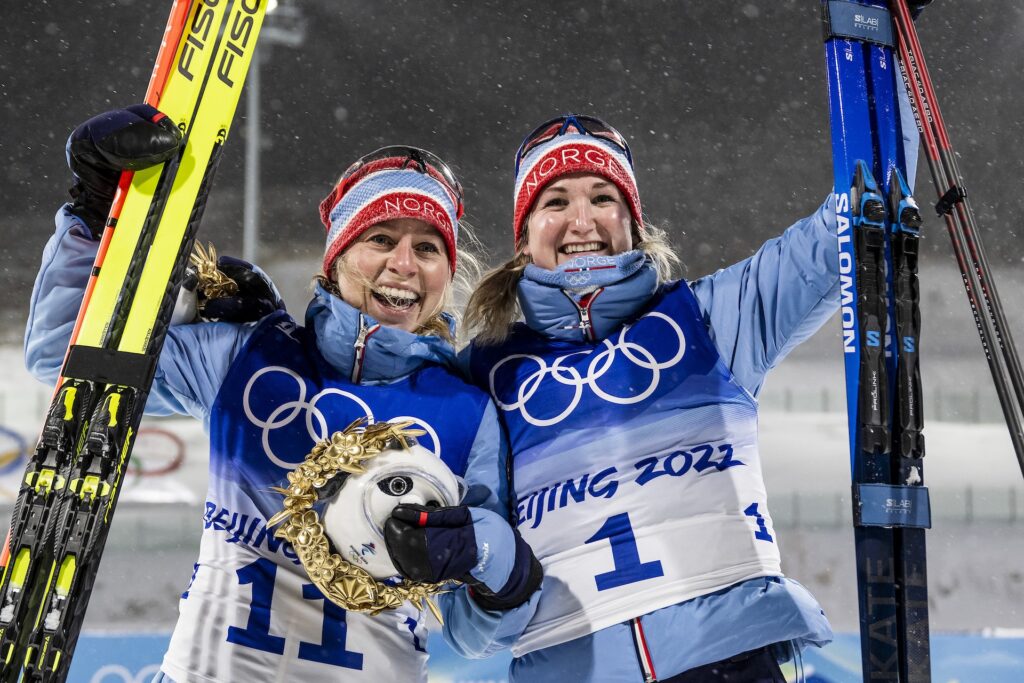 Tiril Eckhoff and Marte Olsbu Røiseland of Norway celebrate after competing in women's biathlon 10 km pursuit during day 9 of the 2022 Winter Olympics on February 13, 2022 in Zhangjiakou.